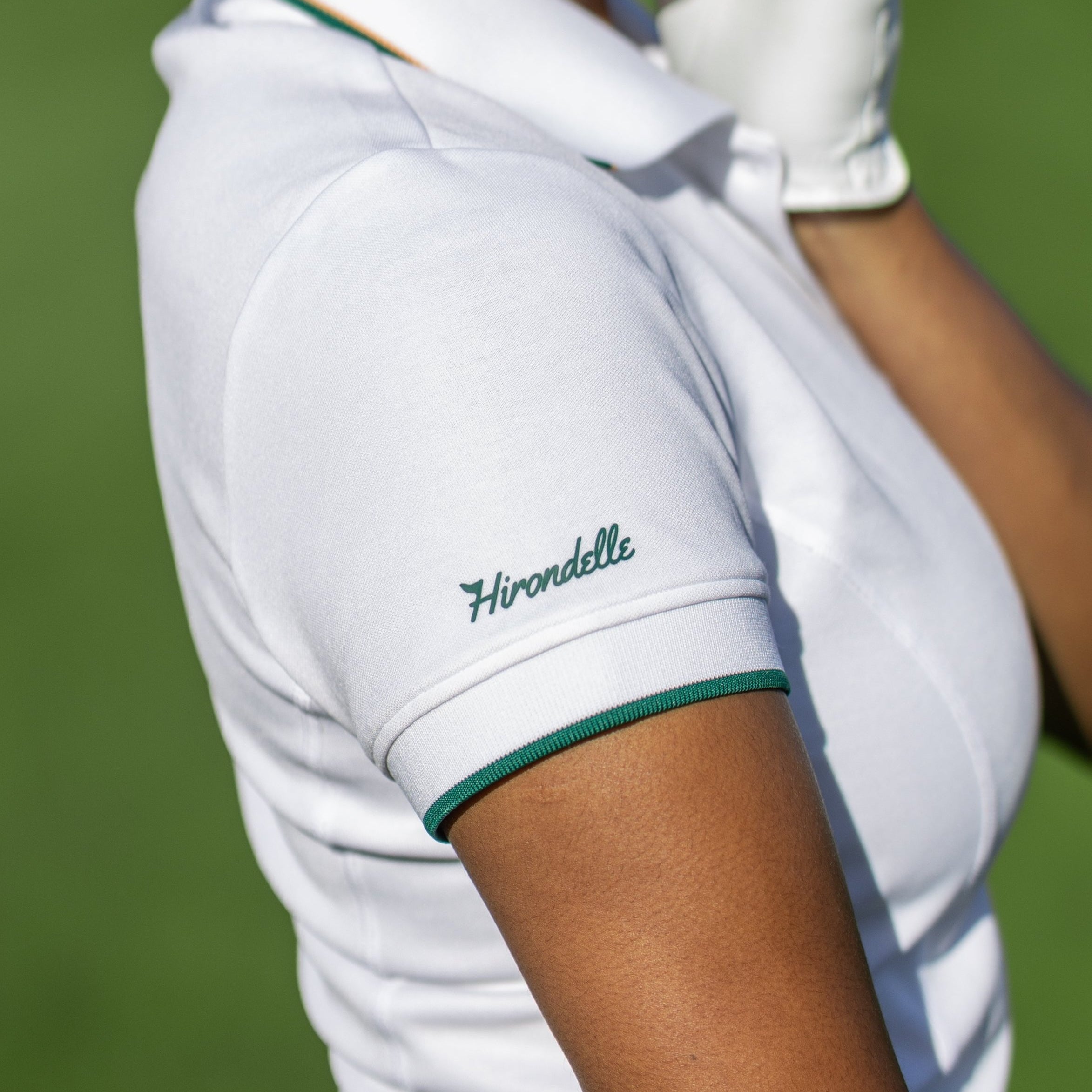 Close-up of a collared black women’s golf polo shirt with button placket