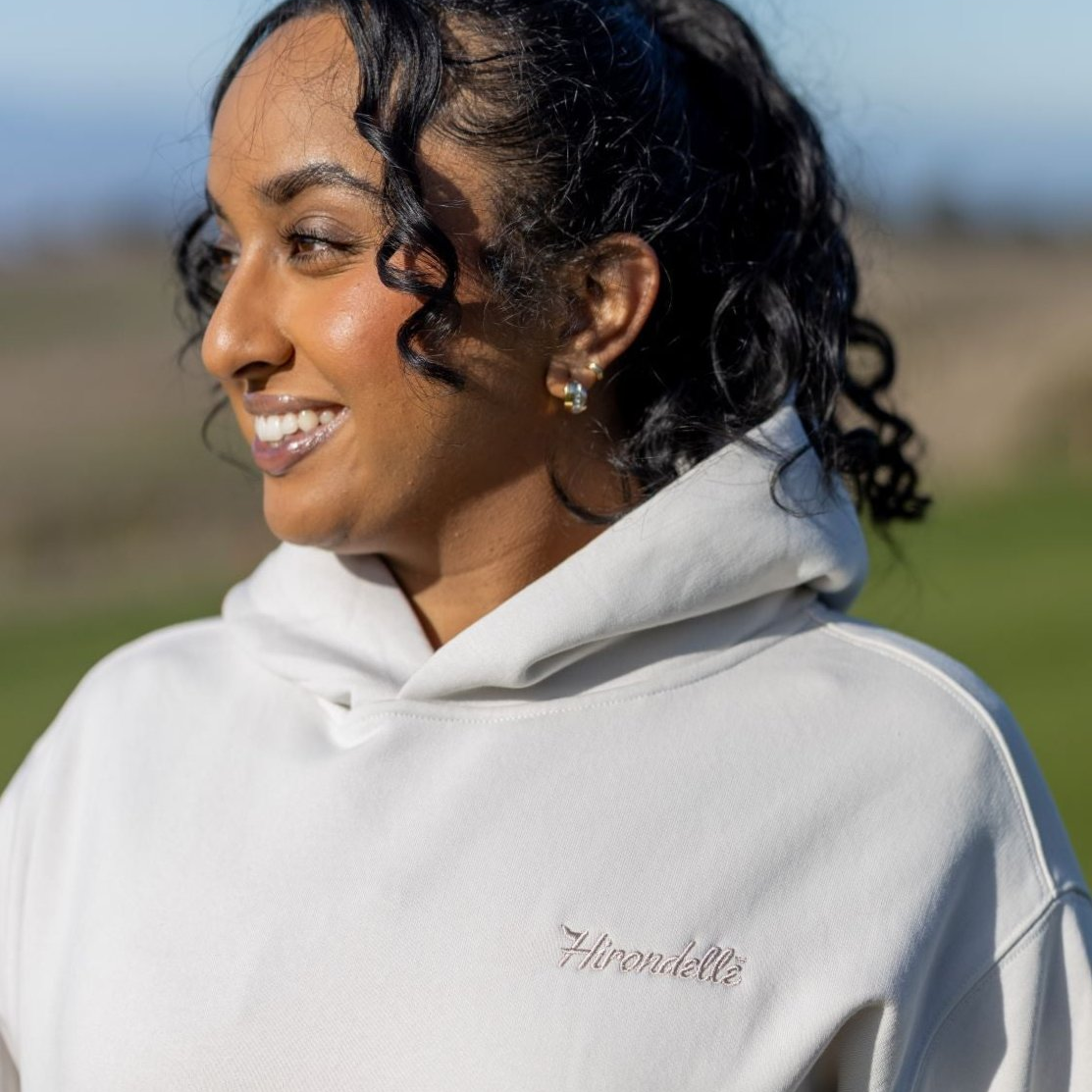 Woman wearing a unisex golf sweater with mental wellness message