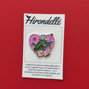 Golf Ball marker with a character in green pants and white hat on a pink heart background named elle from hirondelle 