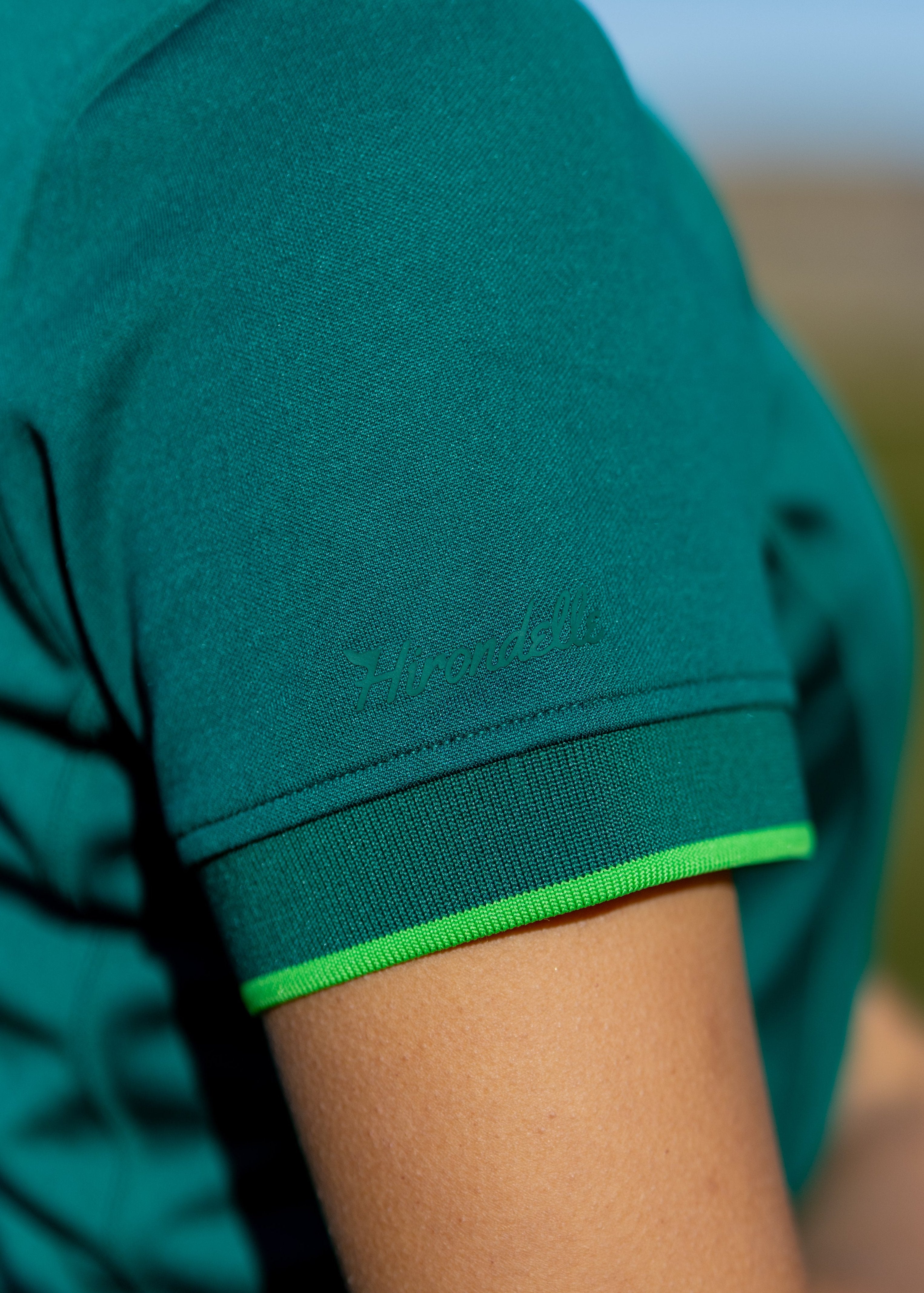 Hirondelle Koko Polo in green logo performance golf apparel
