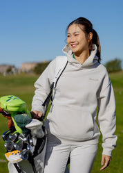 A female golfer wearing Hirondelle Golf Hoodie Tee Time is Me Time to raise mental health awareness 