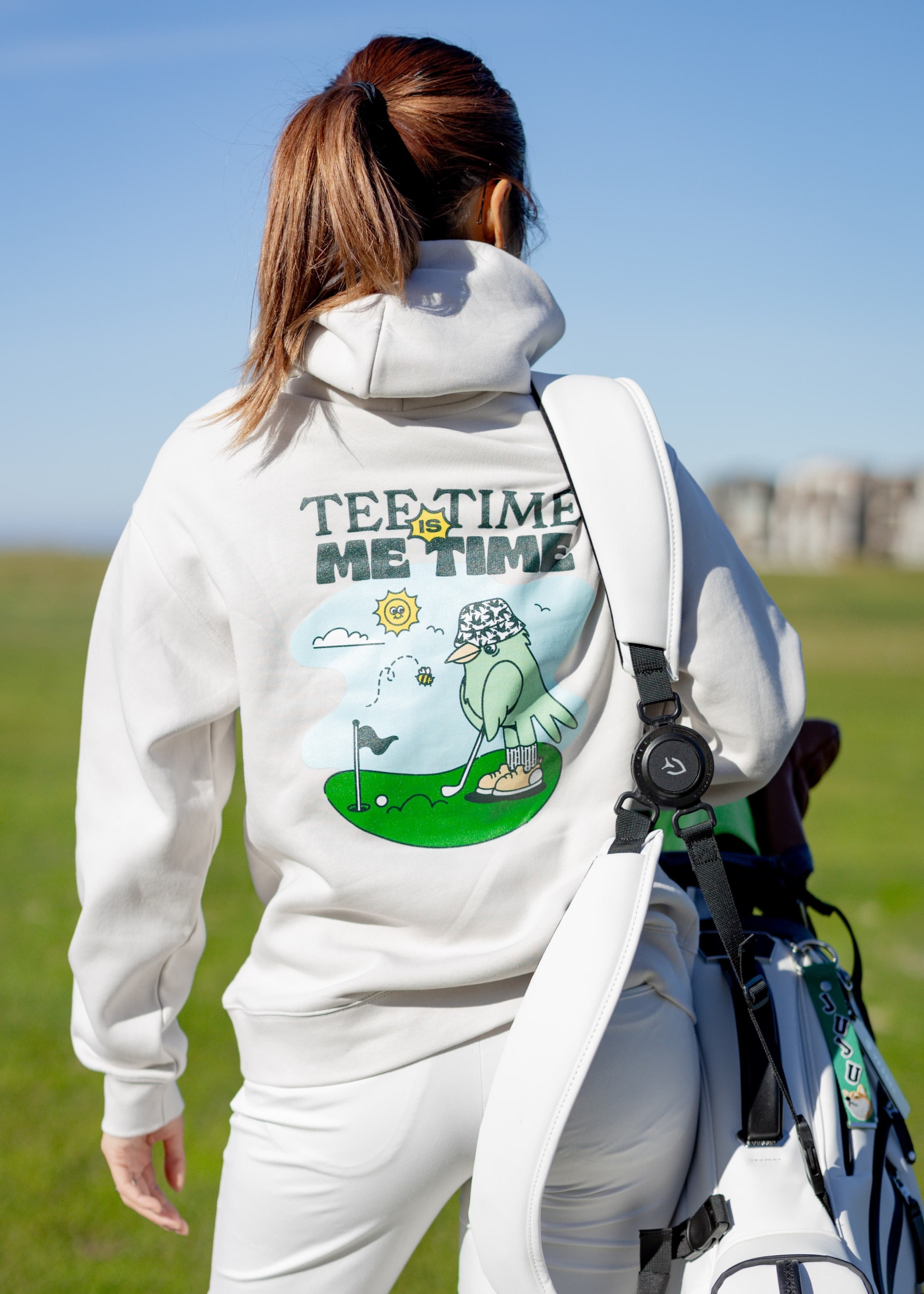 A female golfer wearing Hirondelle Golf Hoodie Tee Time is Me Time to raise mental health awareness 