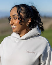 A female golfer wearing Hirondelle Golf Hoodie Tee Time is Me Time to raise mental health awareness 